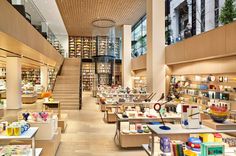 the inside of a bookstore with many books on shelves and tables full of books in it