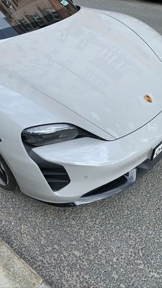 a white sports car is parked on the street