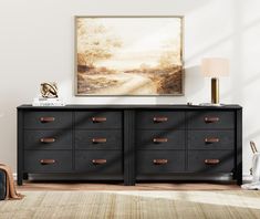 an empty room with a large painting on the wall next to a dresser and chair