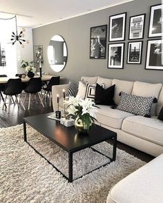 a living room filled with lots of furniture and pictures on the wall above it's coffee table