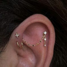 a woman's ear with two piercings attached to it