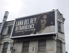 a large billboard on the side of an old building advertising lana del ray's ultraavluiancence