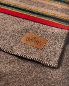 a wool blanket with a leather label on it