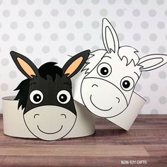 two toilet paper rolls with faces of donkeys and giraffes on them