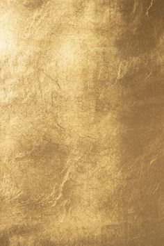 an image of a gold textured background that looks like it has been painted on