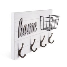 a wooden sign with hooks on it that says home