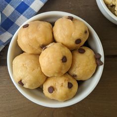 a white bowl filled with chocolate chip doughnuts next to bowls of oatmeal