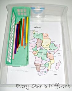 a tray with markers, pencils and a map in it that says africa every star is different