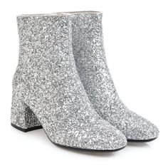 a pair of silver glittered boots with black heel and white soles, on a white background