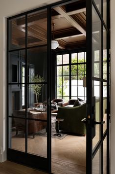 an open living room with glass doors and furniture