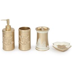 gold bathroom accessories including soap dispenser and toothbrush holder