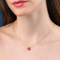 Features * Stylish red necklace with a solitaire pendant on an adjustable 18" chain, including 2-inch extension links. * Gold plated necklace for women with a round red pendant. Simple stone necklaces for women with an 8 mm red cubic zirconia stone. * Gold plated solid silver chain and pendant. This elegant gold necklace for women is made from 18K gold plated 925 Sterling Silver. * Cute gold necklaces for women and teenage girls. High-quality 18K gold plated 925 sterling silver handmade necklace Red Charm Necklace For Gift, Red Jewelry With Adjustable Chain And Round Pendant, Red Round Pendant Charm Necklace, Red Pendant Jewelry With Bezel Setting, Gift Solitaire Necklace With Cable Chain, Red Round Pendant Jewelry With Bezel Setting, Red Round Necklace For Her, Gift Solitaire Necklace With Round Pendant On Cable Chain, Gift Solitaire Birthstone Necklace