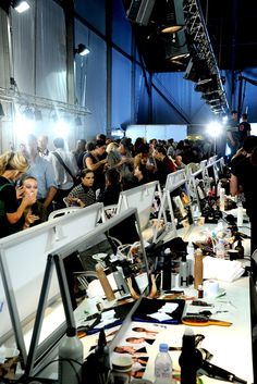 a large group of people are standing in a room