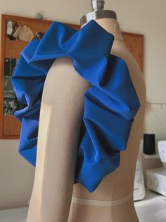 a mannequin with a blue ruffle on it