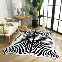 a zebra print rug is on the floor in front of a chair and two chairs