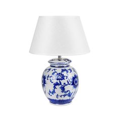 a blue and white table lamp with a white shade on the top, against a white background