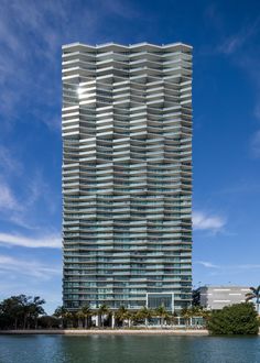 a very tall building sitting next to the ocean