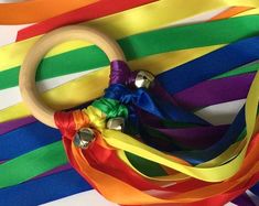 a pair of scissors sitting on top of colorful ribbons