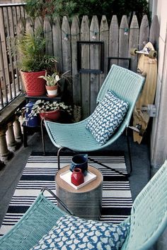 an outdoor patio with blue chairs and potted plants