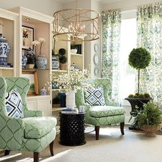 an image of a living room with green chairs