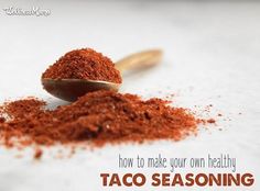 a spoon full of taco seasoning sitting on top of a table