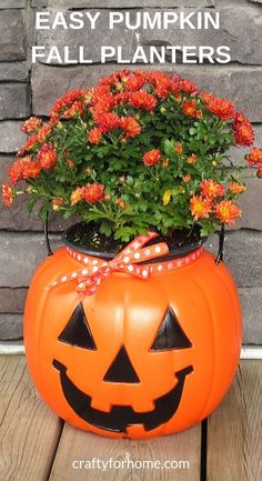 an orange pumpkin planter with flowers in it and the words easy pumpkin fall planters