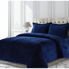 a bed with blue comforter and pillows on it for $ 599 00 sale