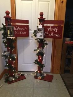 two christmas decorations with lights on them in front of a door