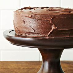 a chocolate cake sitting on top of a wooden table