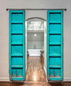 an open blue door leading to a bathroom