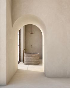 an archway leading into a bathroom with a tub