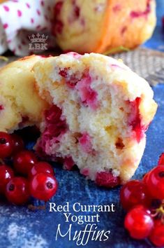 red curran yogurt muffins are cut in half on a blue plate