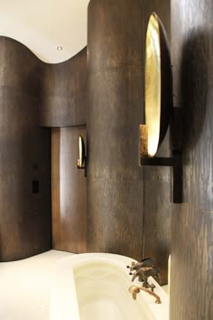 a bathroom with a bathtub and wooden walls