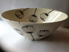 a white bowl with black designs on it