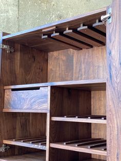 a wooden shelf with several drawers and shelves