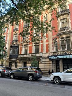 cars are parked in front of an old building