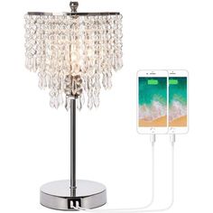 a table lamp that is plugged in to a charger with an iphone charging