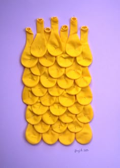 a bunch of bananas are arranged on a purple surface with yellow circles in the middle