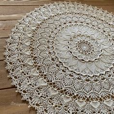 a white doily on a wooden table