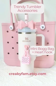 a pink and white bag with a bottle in it next to the words, trendy tumbler accessories mini bag + heart hook