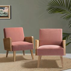 two pink chairs sitting next to each other on a rug