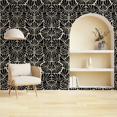 a white chair sitting in front of a black and white wallpaper with an arch