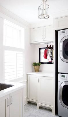 a washer and dryer in a white laundry room