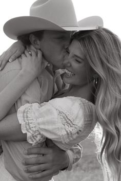 a man in a cowboy hat kissing a woman