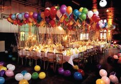 a long table with many balloons on it