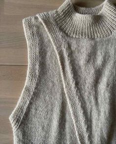 a sweater that is sitting on top of a wooden floor