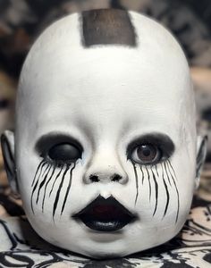 a close up of a child's face with black and white makeup