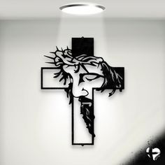 a cross with jesus's face on it is mounted to the wall