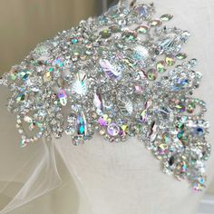 a bridal headpiece with lots of crystal stones on it's side and veil