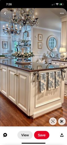 the kitchen is decorated in white and has a chandelier